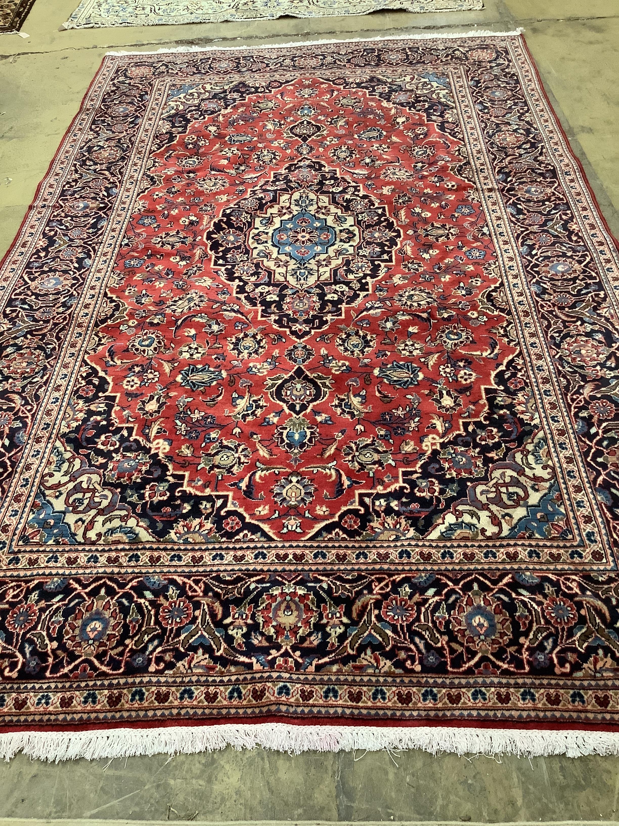 A Kashan red ground carpet, 308 x 190cm